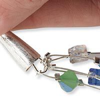 Beading wire looped around wrapped loop with cone terminator